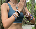 Person wearing multiple EEBracelet on a nature background