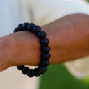 EEBracelet Black Lava on a wrist with a blurred background