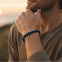 Man with a beard and EEBracelet Hawk Eye looking at the sunset.
