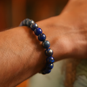 Close-up of a wrist wearing EEBracelet Lapis Lazuli with a blurred background