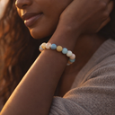 Close-up of a woman's arm wearing EEBracelet Morganite with a blurred background.