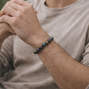 Person wearing EEBracelet Peacock Druzy Agate on a neutral background