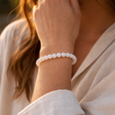 Person wearing EEBracelet White Jade on a blurred background