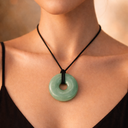 EEMedallion Adventurine  circular pendant necklace worn on a black cord 