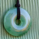 EEMedallion Aventurine on a green textured background