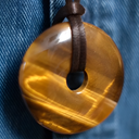 EEMedallion Golden Tiger against a blue denim background