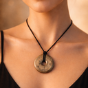 EEMedallion Pyarite Necklace with a circular pendant on a black cord