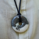 EEMedallion Zebra Jasper on a textured beige fabric background