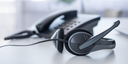 Headset and phone on a desk with a blurred background